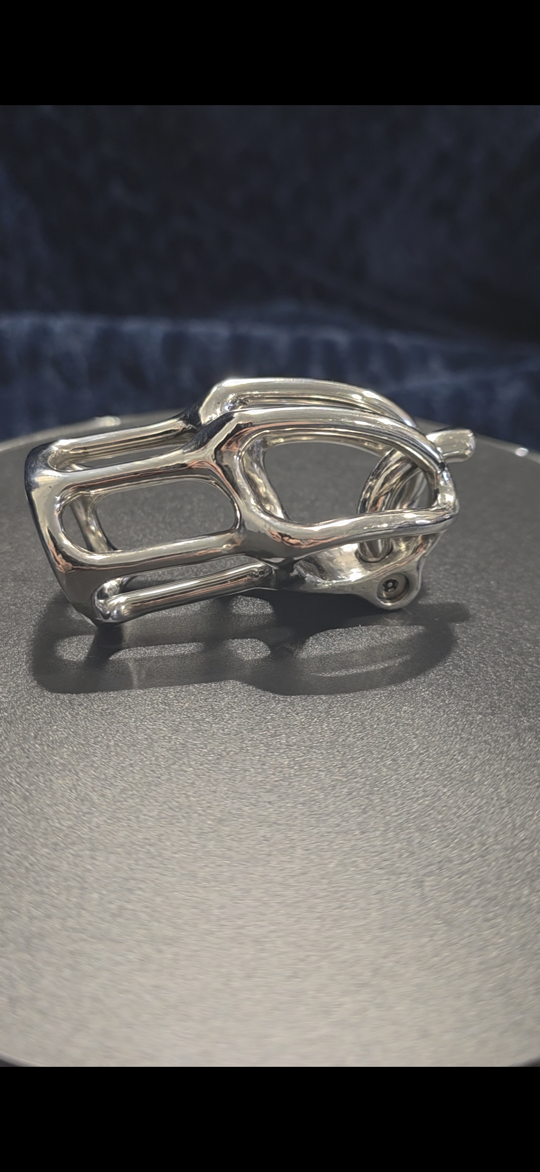 LX-2 open-bar stainless chastity device macro angle